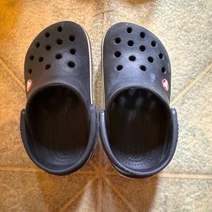 Size 7 crocs. Black with white rim